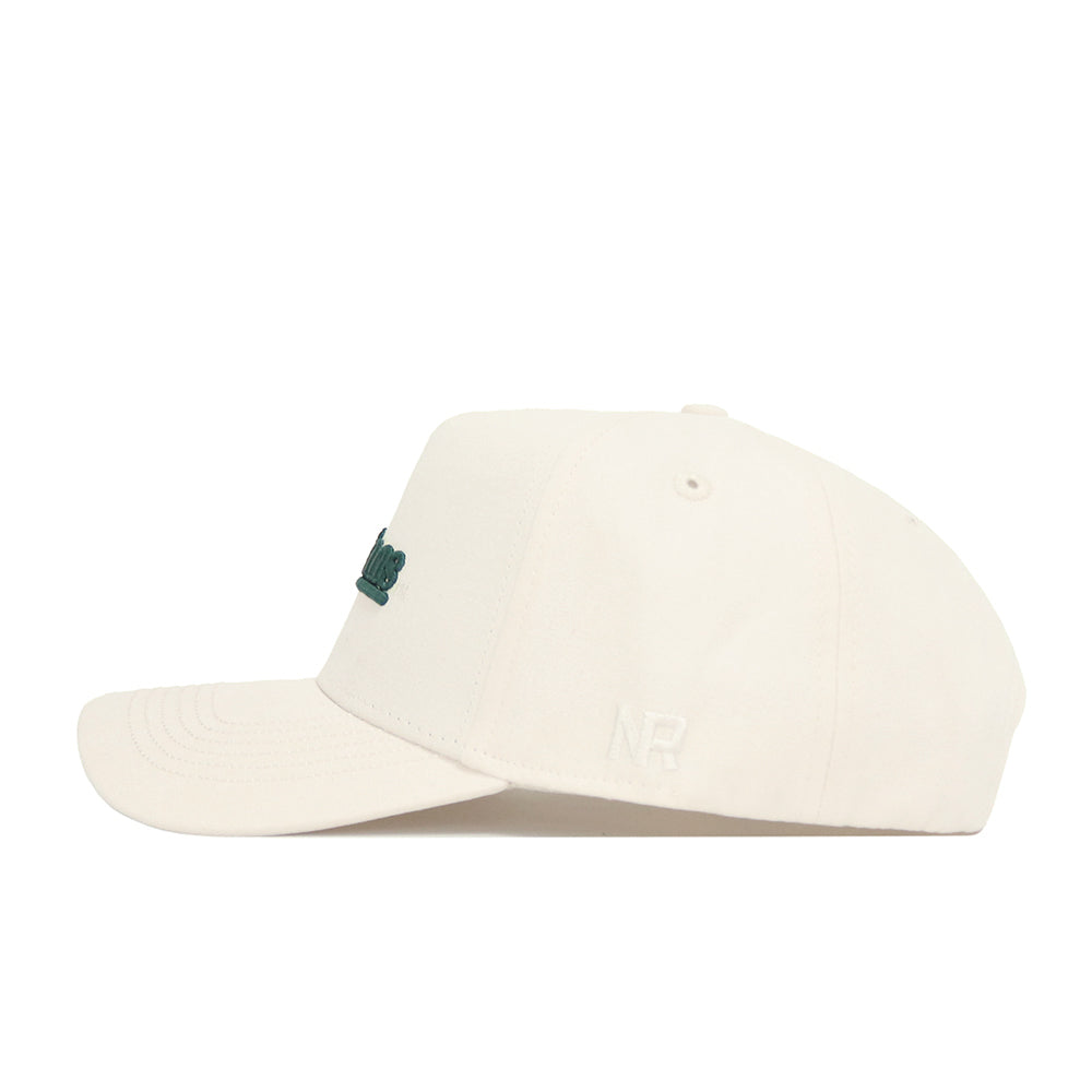 Side view of the Michigan State Sideline Hat by No Rivals, an off-white snapback in premium cotton with a structured fit, subtle NR embroidery on the side, and partially visible green text on the front.