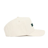 The No Rivals Michigan State Sideline Hat is a beige snapback cap with a green embroidered logo, ventilation eyelets, curved brim, and structured fit. Made from high quality cotton and shown in profile.