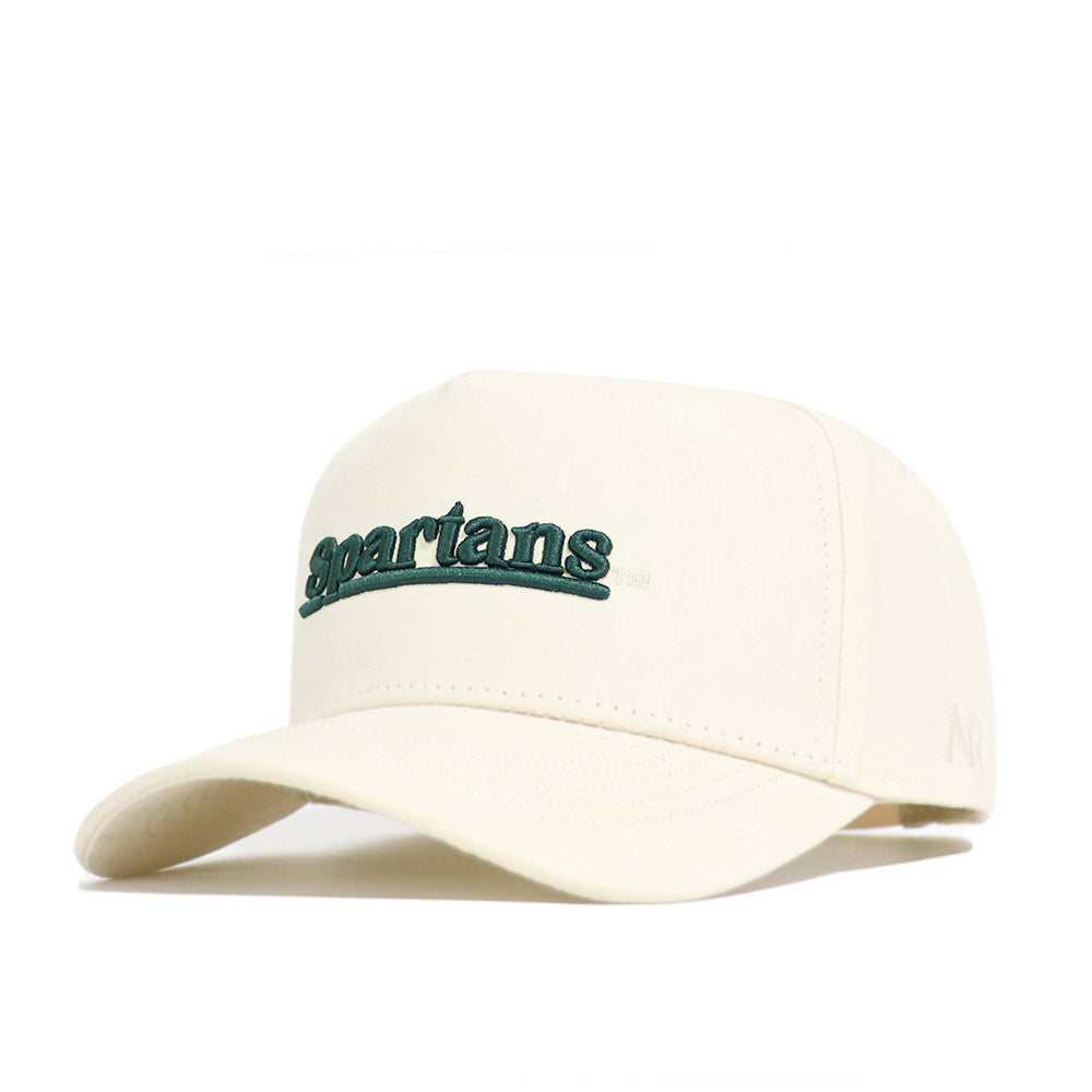 The Michigan State Sideline Hat by No Rivals is a cream-colored cap with a structured crown, curved brim, and high-quality cotton build. "Spartans" is embroidered in green across the front.