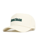 The Michigan State Sideline Hat by No Rivals is a cream-colored cap with a structured crown, curved brim, and high-quality cotton build. "Spartans" is embroidered in green across the front.