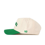 The Upside Down The Herd Hat by No Rivals features a cream-colored snapback design with a green brim and green embroidered "NR" on the side, as shown in a side profile view.
