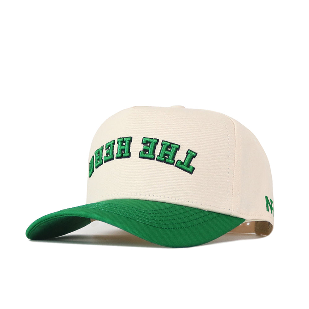 Introducing the Upside Down The Herd Hat - Marshall Thundering Herd by No Rivals, a beige baseball cap with a green brim. This snapback features "THE HERD" embroidered in green, outlined in black, and flipped upside down on the front.