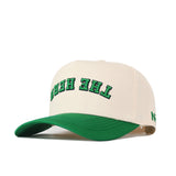 Introducing the Upside Down The Herd Hat - Marshall Thundering Herd by No Rivals, a beige baseball cap with a green brim. This snapback features "THE HERD" embroidered in green, outlined in black, and flipped upside down on the front.