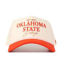 Introducing the OSU Vintage Hat by No Rivals—a premium white and orange snapback crafted from high quality cotton, showcasing bold embroidery with “Oklahoma State Cowboys” and “EST 1890” in striking orange and gold on the front. The perfect finishing touch to your gameday outfit!.