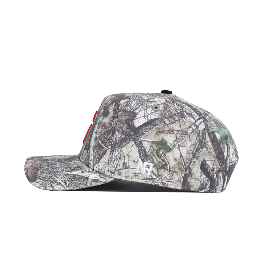 A side view of the No Rivals Syracuse Outland Hat shows its camouflage snapback design with a flat brim, red embroidered letters on the front, and a small white NR logo by the brim. Made from high quality cotton for comfort and durability.