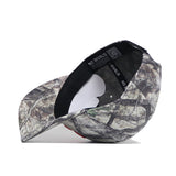 The Syracuse Outland Hat by No Rivals, a high-quality cotton snapback with a camouflage pattern, is shown on its side to display the inner band’s NO RIVALS label and a white sticker on the brim.
