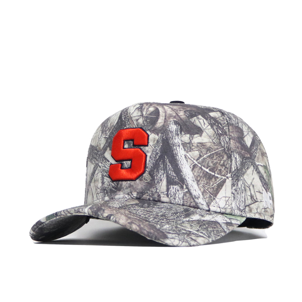 The Syracuse Outland Hat by No Rivals is a high-quality cotton snapback with a forest camo pattern, curved brim, and bold red 'S' embroidered on the front.