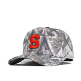 The Syracuse Outland Hat by No Rivals is a high-quality cotton snapback with a forest camo pattern, curved brim, and bold red 'S' embroidered on the front.