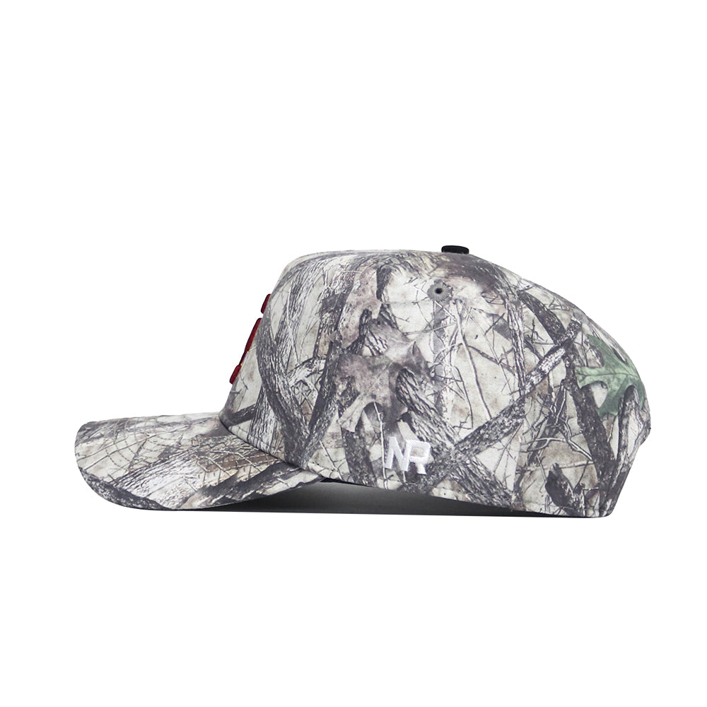 Side view of the No Rivals USC Outland Hat, a structured fit snapback with a flat brim and camouflage pattern in brown, green, and gray cotton. Features a white NR logo on the side.