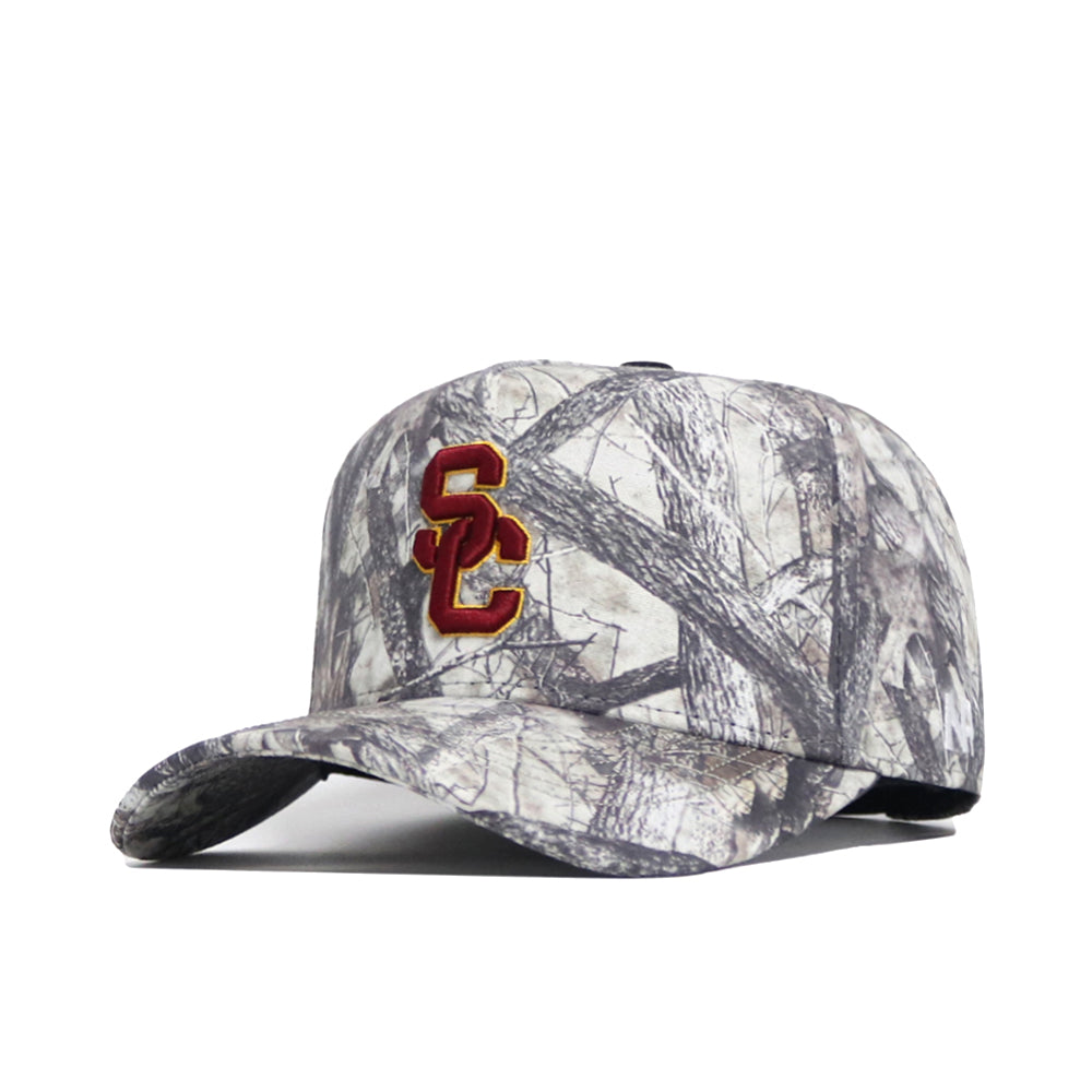 The USC Outland Hat by No Rivals is a gray camo snapback with a red and gold SC logo embroidered on the front, made from premium cotton for a structured, comfortable fit.