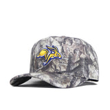 The South Dakota State Outland Hat by No Rivals is a structured camo baseball cap with an embroidered yellow and blue jackrabbit logo, made from premium cotton and features a snapback closure.