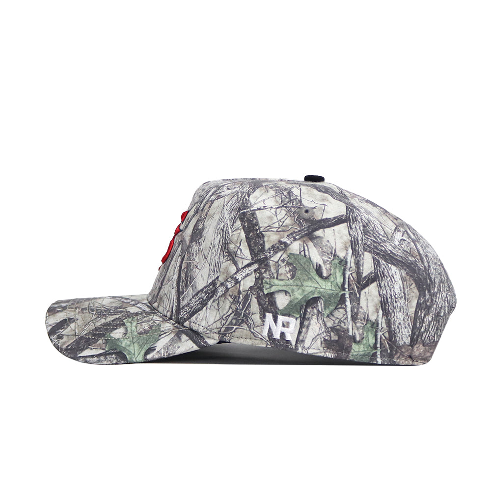 Side view of the Fresno State Outland Hat by No Rivals, a structured camo snapback with tree and leaf patterns, red embroidered front letters, and a white NR logo on the side.