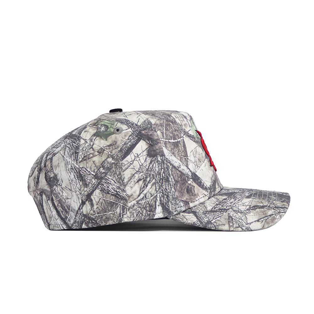 The No Rivals Fresno State Outland Hat is a high quality cotton snapback with a camouflage pattern, flat brim, and a partially visible red embroidered logo on the front, shown from the side.