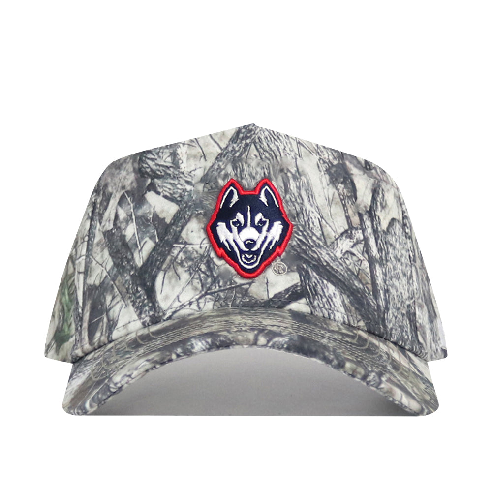 The UConn Outland Hat by No Rivals is a camo baseball cap with an embroidered husky logo outlined in red on the front, made from high-quality cotton and designed with a snapback for adjustable fit.