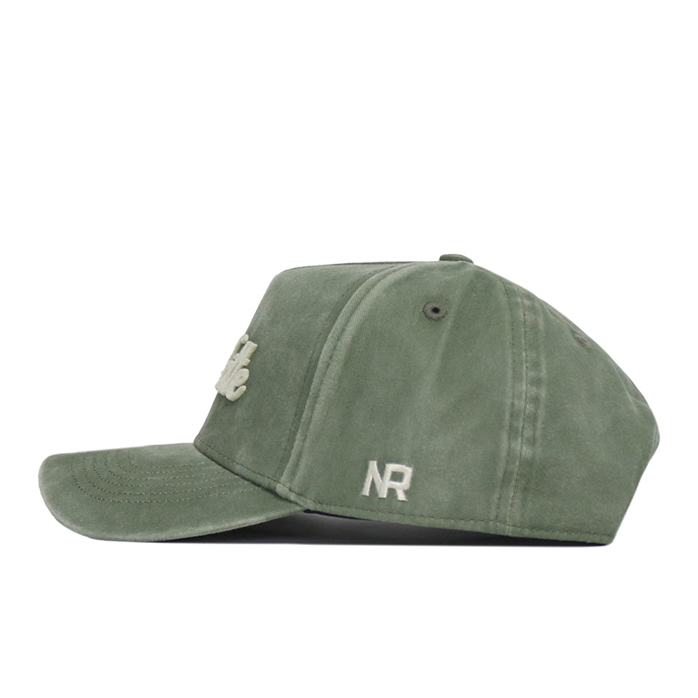 Side view of the Charlotte Home Turf Hat by No Rivals, featuring a green snapback design with white embroidered “NR” near the brim and additional white embroidery on the front panel. This cap showcases visible stitching, a curved bill, and signature embroidered logos—perfect for completing your gameday fit.