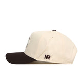 A cream-colored Penn State Espresso Hat by No Rivals, featuring a black brim and side view. Made from high-quality cotton, this structured snapback cap showcases the “NR” embroidery in black near the back.