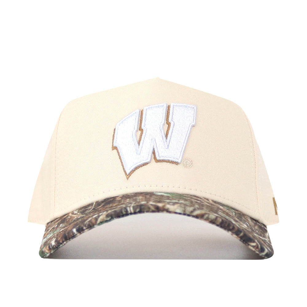 The No Rivals Wisconsin Camo Connector Hat is a beige snapback featuring a prominent white W outlined in brown embroidered on the front, with a camouflage-patterned brim—perfect for completing your gameday fit.