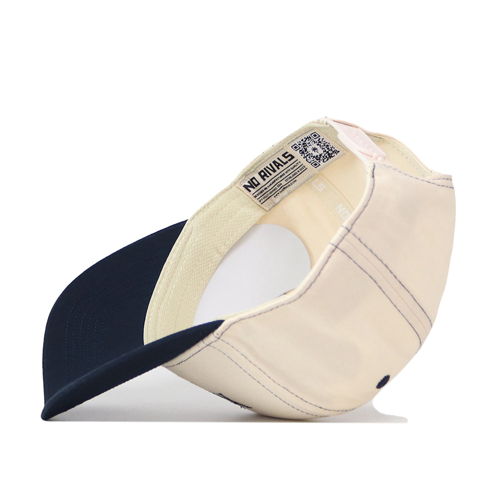 A Xavier Musketeers Vintage Hat by No Rivals is displayed upside down, highlighting the inside label that reads NO RIVALS. The cap features a navy brim, visible inner stitching, and an embroidered logo for signature detail—an ideal snapback for a perfect gameday fit.