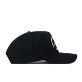The Mississippi State Outlaw Hat by No Rivals is displayed from a side angle, featuring subtle white embroidery on the front. This black snapback showcases a curved brim and structured construction, making it an ideal finishing touch to your gameday ensemble.