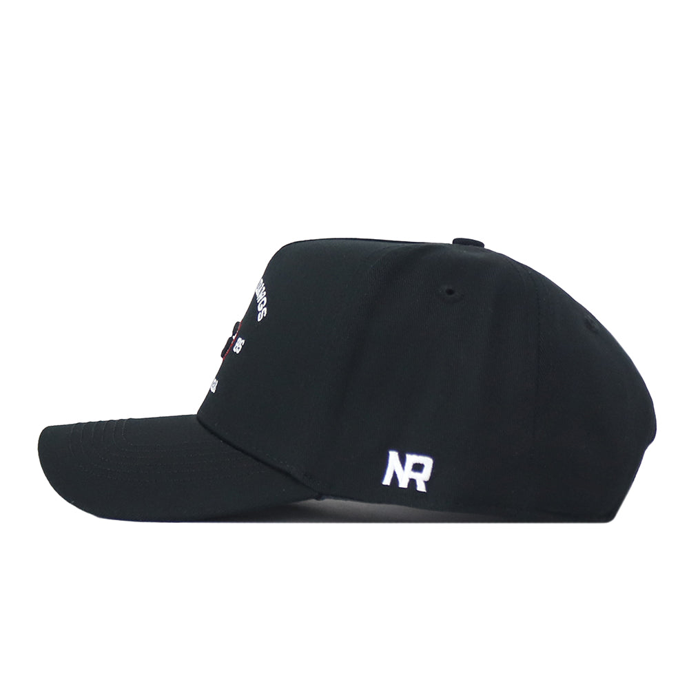 The Georgia Outlaw Hat - Black by No Rivals is showcased from the side, highlighting crisp white embroidered NR initials and a hint of its subtle front design. Crafted with a classic snapback closure for adjustable comfort, this cap ensures the perfect Gameday Fit.