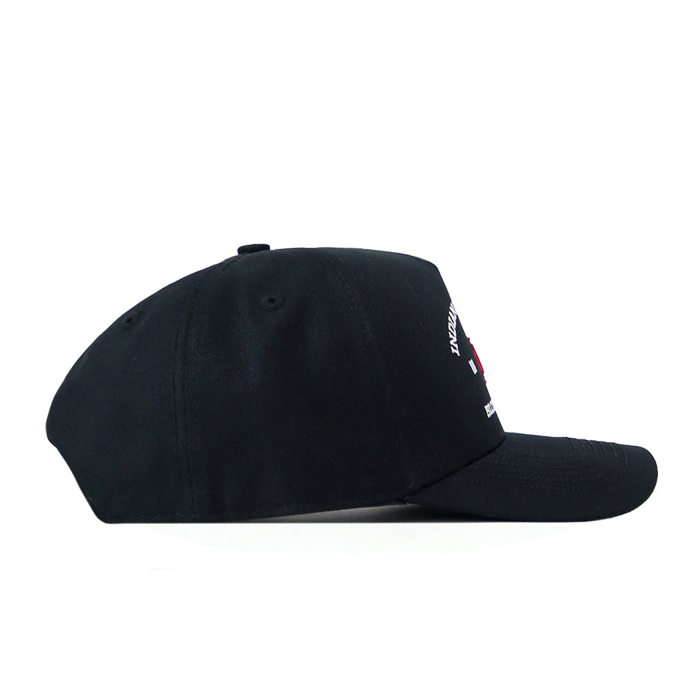 The Indiana Outlaw Hat - Black by No Rivals is displayed in a side profile view, showcasing its curved brim and understated design, accentuated by an embroidered logo for a refined touch of style.