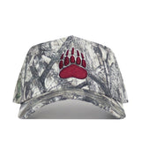 The Montana Outland Hat by No Rivals is a high-quality cotton camouflage baseball cap with a structured fit and an embroidered bold red bear paw print on the front.