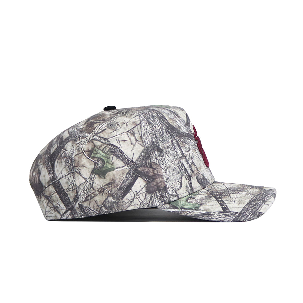 The No Rivals Montana Outland Hat is a high-quality cotton snapback with a camouflage pattern, flat brim, and structured fit, displayed from the side on a white background.