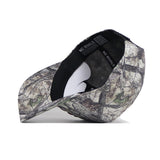 The Montana Outland Hat by No Rivals is a premium cotton camouflage baseball cap with "NO RIVALS" printed on the inner band. Shown upside down to highlight its structured fit and brim against a white background.