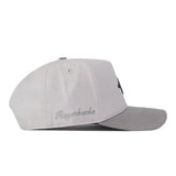 A light gray Arkansas Graphite Hat by No Rivals is shown from the side, featuring “Razorbacks” embroidered in cursive above the brim for a standout logo and classic gameday fit.