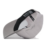 A No Rivals Arkansas Graphite Hat is flipped upside down, displaying its black inner band and tags with NO RIVALS text, along with a visible QR code inside the crown. The classic snap back design provides a comfortable fit for gameday, while an embroidered logo offers a bold finishing touch.