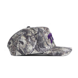 A side view of the No Rivals TCU Outland Hat, a camouflage baseball cap with purple embroidered letters on the front and a structured fit, set against a plain white background.