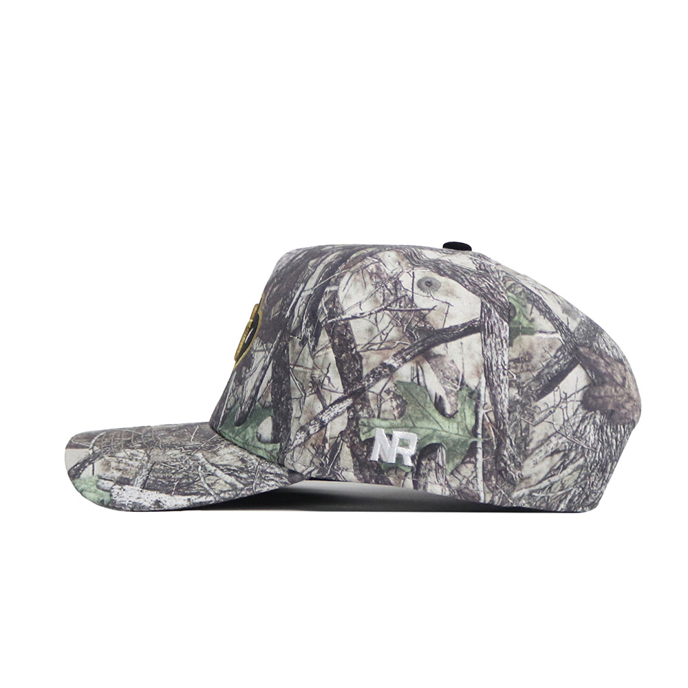 The Colorado Outland Hat by No Rivals is a camouflage flat-brim baseball cap, shown side view, made of high-quality cotton with white "NR" embroidery near the brim and an adjustable snapback for comfort.