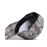 The No Rivals Colorado Outland Hat, a high-quality cotton baseball cap with a camouflage pattern, is shown from the side and above. Its structured fit displays the interior and black inner band, with the brim facing left.