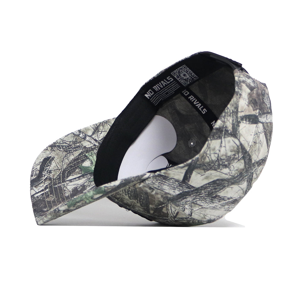 The ETSU Outland Camo Hat by No Rivals is shown on its side, displaying the interior band with the brand name and structured fit, along with its quality cotton construction and camo-patterned snapback design.