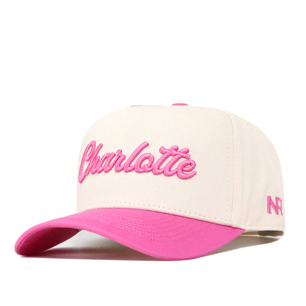 Show your Charlotte pride with the UNC Charlotte Pink Out Hat by No Rivals. This cream-colored snapback features “Charlotte” embroidered in pink on the front, a stylish pink brim, and pink NR logo detailing stitched on the side—making it a standout addition to your gameday outfit.