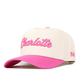 Show your Charlotte pride with the UNC Charlotte Pink Out Hat by No Rivals. This cream-colored snapback features “Charlotte” embroidered in pink on the front, a stylish pink brim, and pink NR logo detailing stitched on the side—making it a standout addition to your gameday outfit.