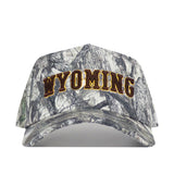 The No Rivals Wyoming Outland Hat is a camouflage snapback with a structured fit and WYOMING boldly embroidered in yellow with brown trim on the front.