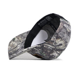 The Wyoming Outland Hat by No Rivals is pictured upside down, showing its black sweatband and NO RIVALS label. The snapback features a forest-inspired camouflage pattern on high-quality cotton brim and panels.