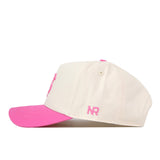 Introducing the Florida State Pink Out Hat by No Rivals—a white baseball cap with a pink brim and pink embroidered “NR” initials on the side. It features a convenient snap back adjustment for a comfortable fit. This officially licensed hat is both stylish and supportive, perfect for showing your support during Breast Cancer Awareness events.