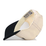 A beige and black Wichita State Vintage Hat by No Rivals is shown inside out, revealing inner tags, stitching, Structured Fit, and a NO RIVALS label.