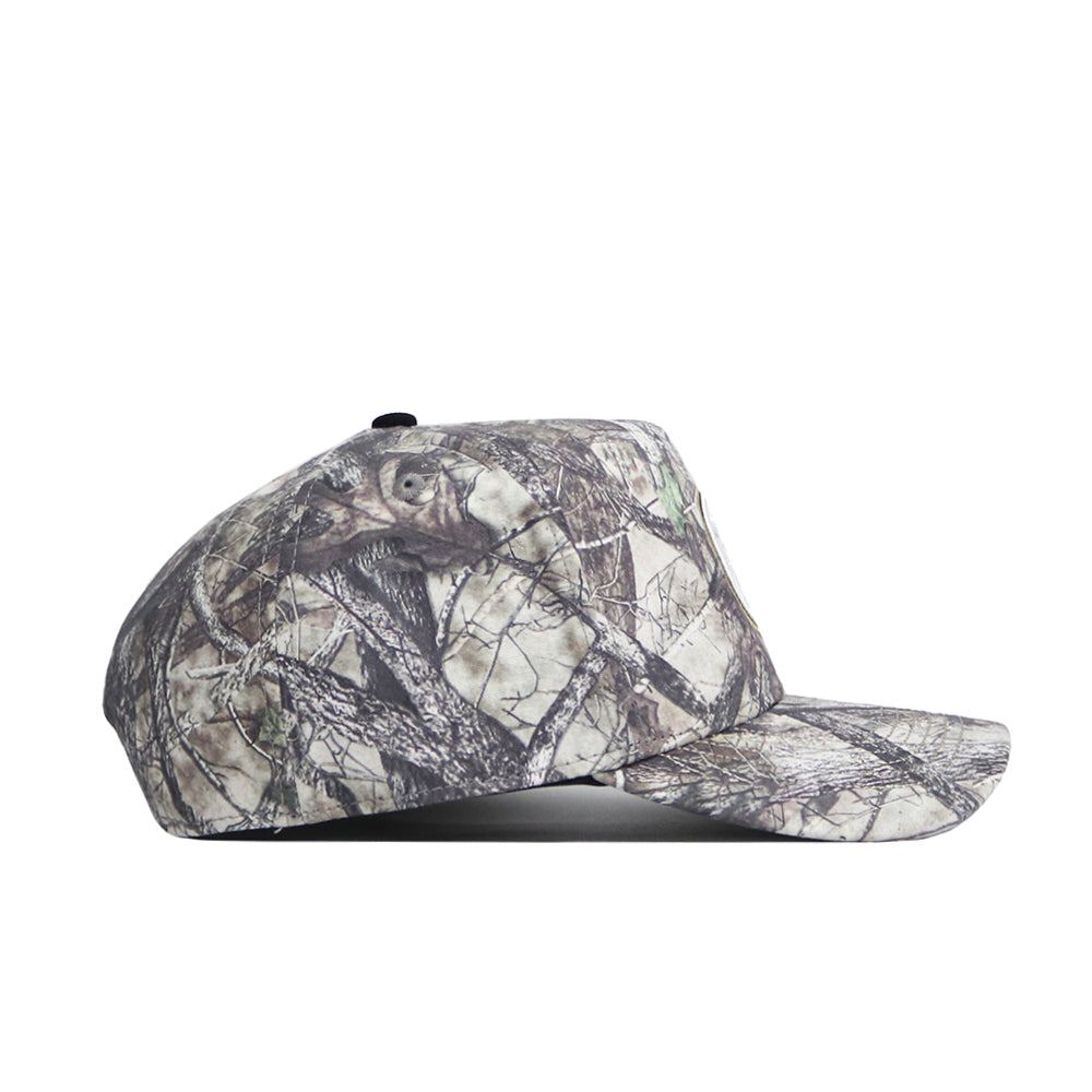 A side view of the No Rivals Colorado State Outland Hat, a snapback with a camouflage design of tree branches and leaves in muted brown, gray, and green cotton for a comfortable, structured fit.