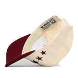 The Texas A&M Star Hat by No Rivals is shown upside down, revealing a “NO RIVALS” label inside the rim and multiple star designs on the side. This snapback style features an embroidered logo, offering both comfort and standout details for fans and collectors alike.