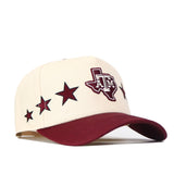 The Texas A&M Star Hat by No Rivals is a cream and maroon snapback featuring an embroidered Texas A&M logo on the front, maroon stars along the side, a maroon bill, and is officially licensed.