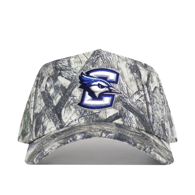 The Creighton Outland Hat by No Rivals is a camouflage snapback with a bold blue and white "C" and blue jay bird logo embroidered on the front, crafted from high-quality cotton for a structured fit.