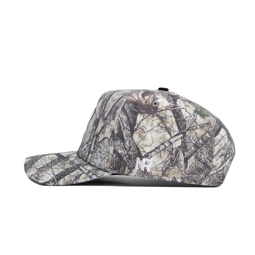 A side view of the No Rivals Creighton Outland Hat, a structured fit cap with a flat brim and woodland camo pattern. "NF" is embroidered in white near the back, crafted from high-quality cotton for comfort and durability.
