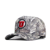 The No Rivals Utah Outland Hat is an officially licensed camo baseball cap with a red U logo outlined in black on the front and a small NE stitched on the side.