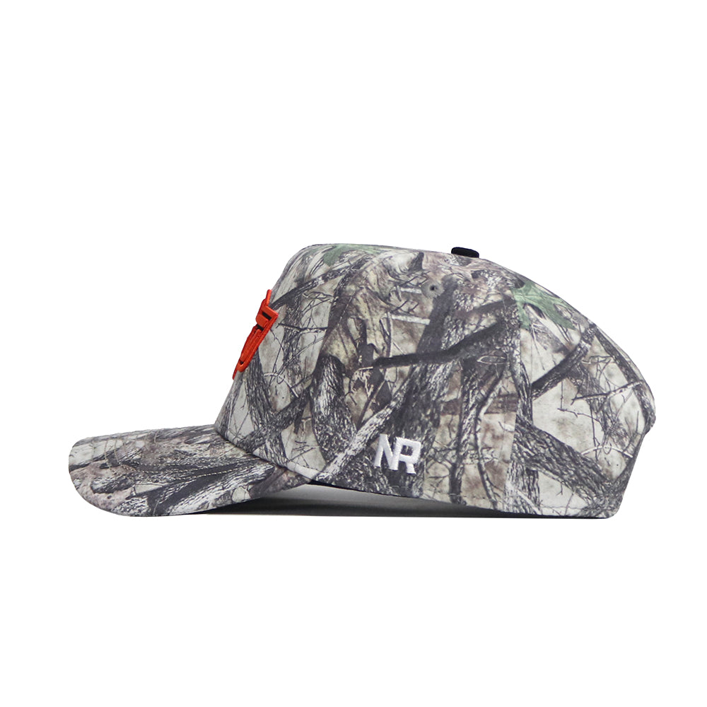 A side view of the No Rivals Oklahoma State Outland Hat, a structured camouflage cotton baseball cap with a red embroidered logo on the front, white "NR" letters on the side, and an adjustable snapback closure.