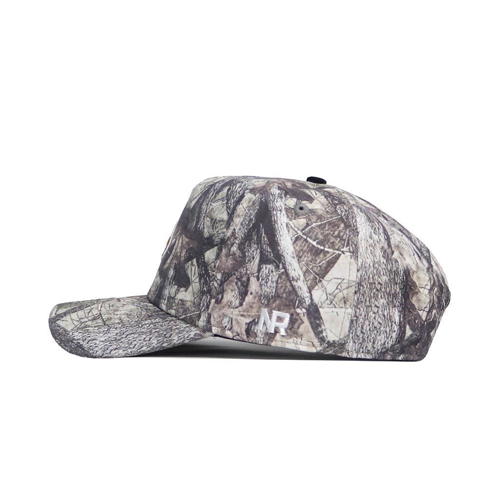 The No Rivals Louisville Outland Hat is a high-quality cotton camouflage snapback featuring a woodland pattern and white NR embroidery on the side, displayed in a left profile view against a white background.