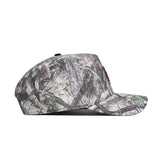 Side view of the No Rivals Texas State Outland Hat, a structured flat-brim cap with a forest camouflage pattern of branches and leaves, crafted from high-quality cotton and shown against a white background.