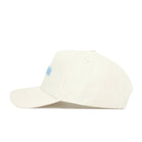 The No Rivals North Carolina Sideline Hat is a cream snapback made from high quality cotton, featuring light blue embroidered lettering on the front and white NR initials stitched on the side. The structured cap is shown in side view on a white background.
